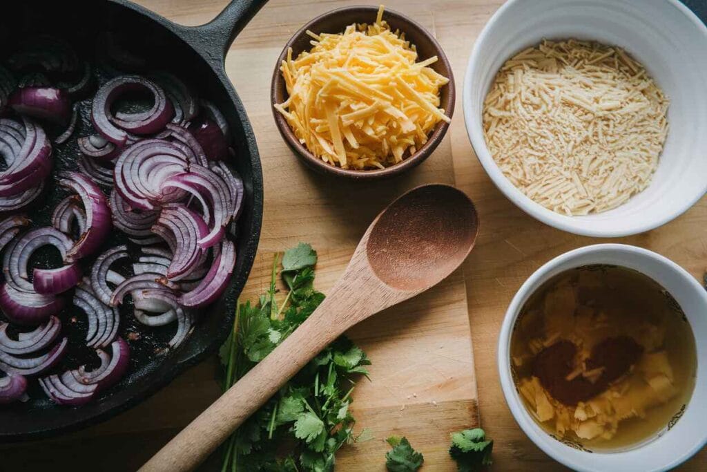 Overhead view of caramelized onions and ingredients for French Onion Soup Rice